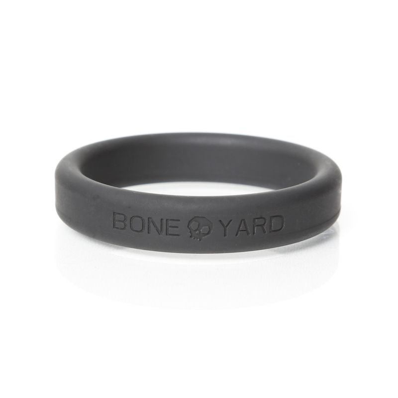 Close view of a flat black Boneyard silicone ring with embossed brand name
