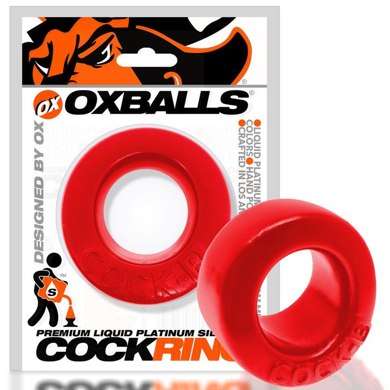 Red Cock B ring pictured beside its retail packaging, showing the deeper padded base
