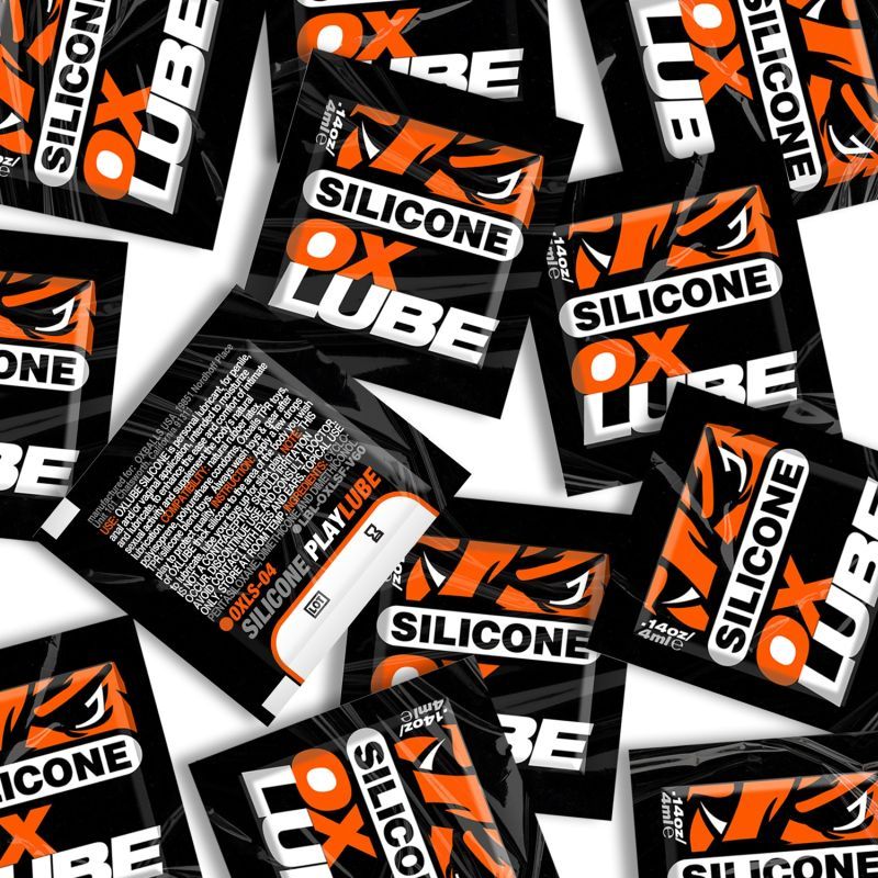 Orange and black OxBalls Silicone OXLube 4ml sachets, with front designs and one reverse label visible
