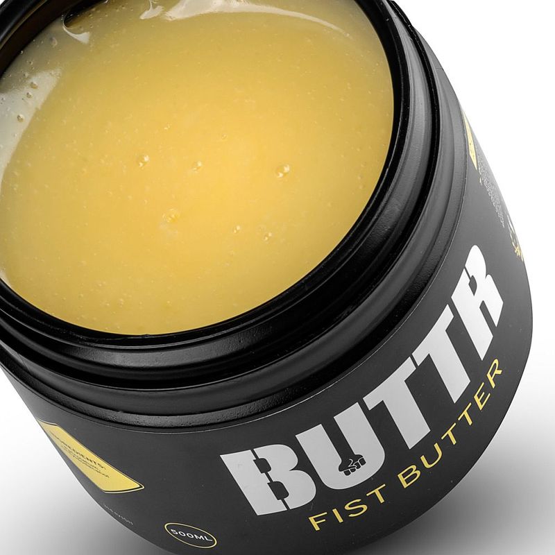 Open BUTTR Fisting Butter tub showing the thick yellow buttery lubricant texture
