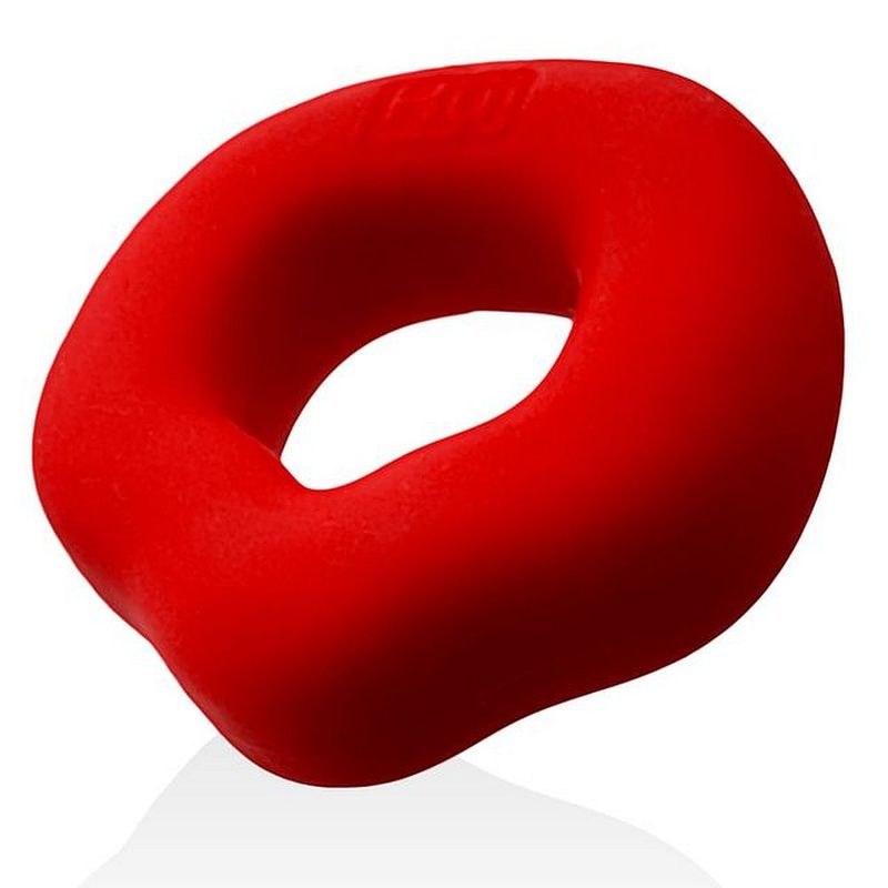 Angled view of the red Hunkyjunk Fit Grips cock ring