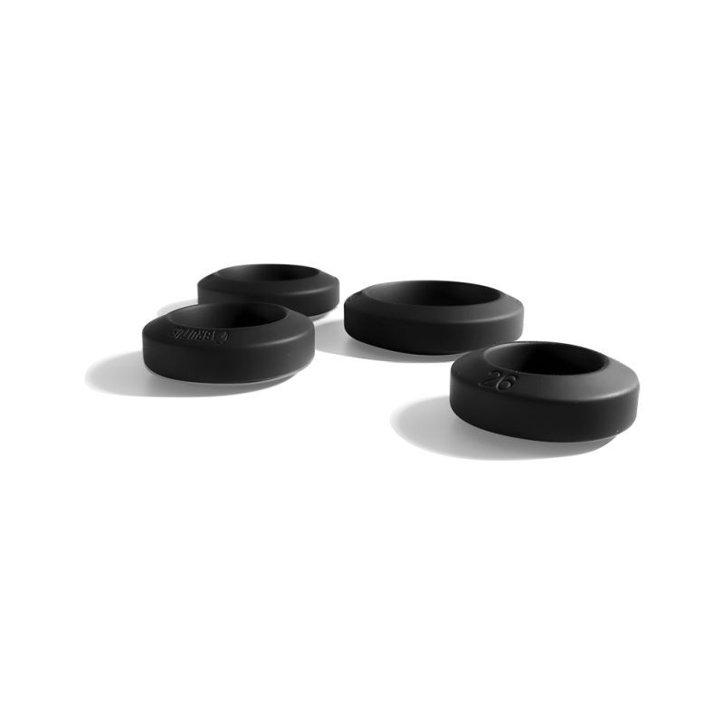 Brutus Big Bulge black silicone cock rings laid out separately, showing the four opening sizes and rounded bands
