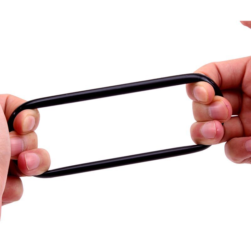 A black GK Power Mega Donut cock ring stretched between two hands to demonstrate the flexible TPE