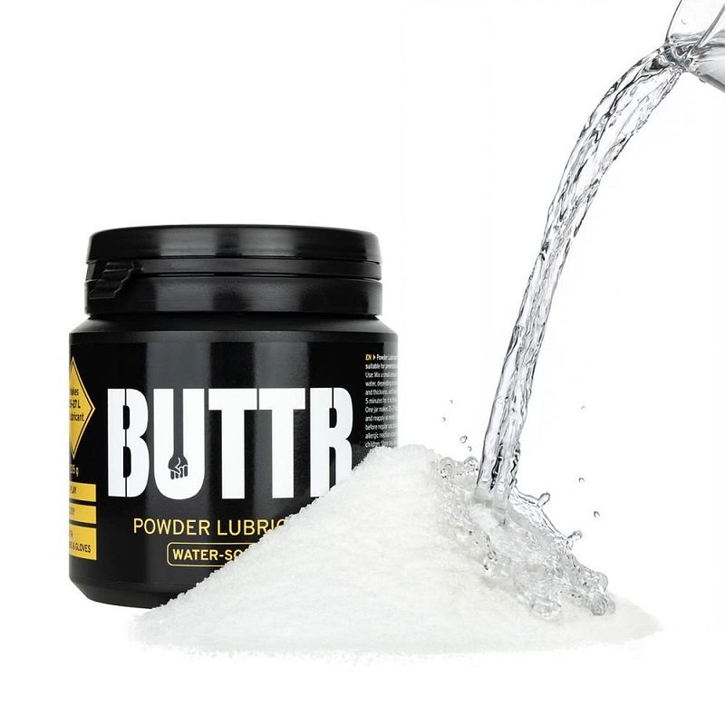 BUTTR Powder Lube promotional image with water poured onto white powder beside the 135g tub