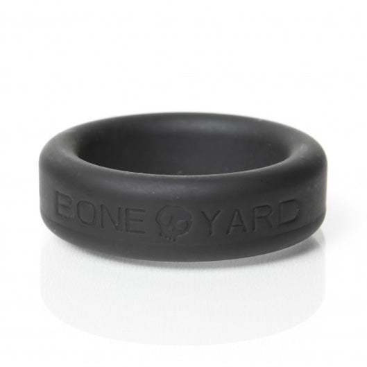 Side view of the black Boneyard Silicone Cock Ring 30mm showing its broad band and logo