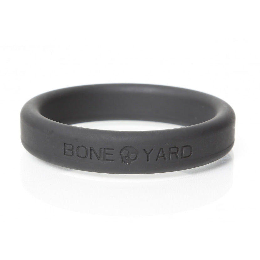 Side view of the Boneyard 50mm black silicone cock ring showing its flat band and lettering